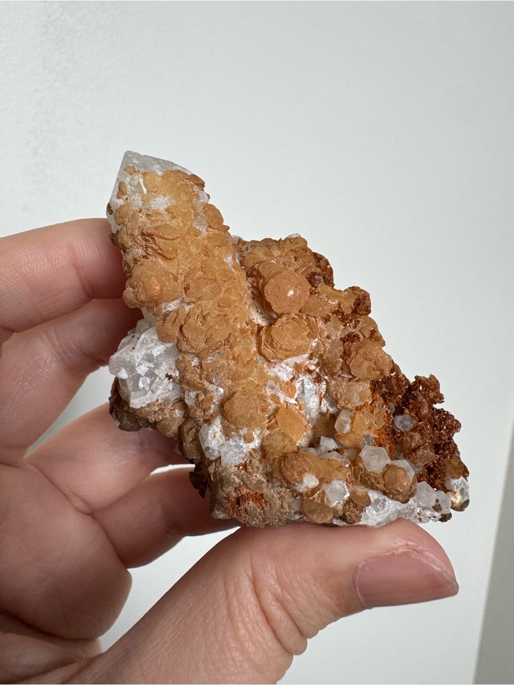 Crystal cluster with yellow-brown mineral skin